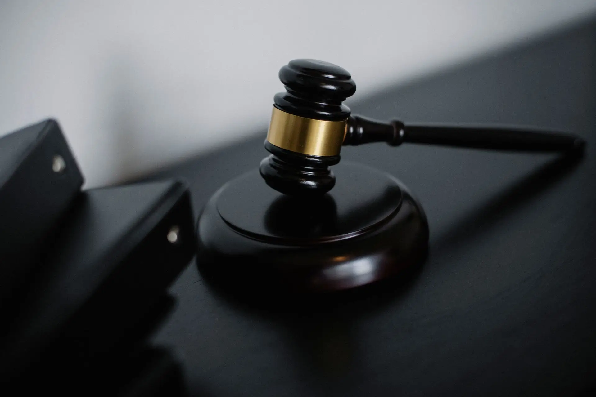 An auction gavel resting on its block